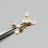 18k gold stud earrings featuring three round diamonds in a bezel setting