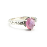 Oval pink sapphire ring in prongs setting with sterling silver hammer texture band