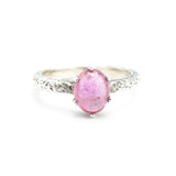 Oval pink sapphire ring in prongs setting with sterling silver hammer texture band