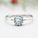 Round blue topaz ring in silver bezel setting with sterling silver hammered texture band