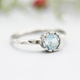 Round blue topaz ring in silver bezel setting with sterling silver hammered texture band