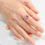 Oval pink sapphire ring in prongs setting with sterling silver hammer texture band