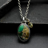 Oval turquoise pendant necklace in silver bezel setting with green multi-sapphire gemstone