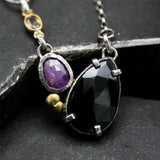 Teardrop black onyx necklace with pink sapphire in silver bezel and prongs setting