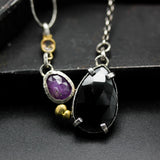 Teardrop black onyx necklace with pink sapphire in silver bezel and prongs setting