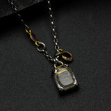 Golden rutilated quartz pendant necklace in silver bezel and prongs setting with sterling silver chain