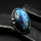 Oval cabochon blue Labradorite cocktail ring in silver bezel and prongs setting with sterling silver band