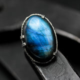 Oval cabochon blue Labradorite cocktail ring in silver bezel and prongs setting with sterling silver band