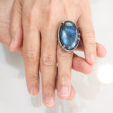 Oval cabochon blue Labradorite cocktail ring in silver bezel and prongs setting with sterling silver band