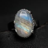 Oval cabochon Moonstone ring in bezel and prongs setting with sterling silver hammer texture thick band