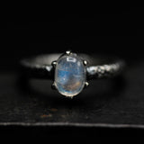 Tiny oval moonstone ring in silver prongs setting with sterling silver hard texture oxidized band