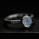 Tiny oval moonstone ring in silver prongs setting with sterling silver hard texture oxidized band