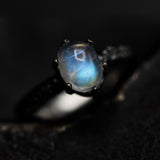 Tiny oval moonstone ring in silver prongs setting with sterling silver hard texture oxidized band