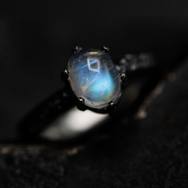 Tiny oval moonstone ring in silver prongs setting with sterling silver hard texture oxidized band