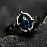 Oval cabochon blue kyanite ring in silver bezel and 4 prong setting with sterling silver texture design band