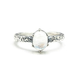 Tiny oval moonstone ring in silver prongs setting with sterling silver hard texture oxidized band