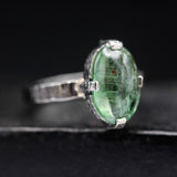 Oval cabochon green kyanite ring in silver bezel and prongs setting with sterling silver texture band