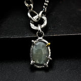 Oval faceted sapphire pendant necklace in silver bezel and prongs setting