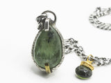 Close up of the green kyanite in a textured silver bezel