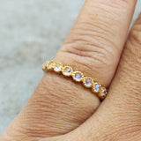 Tiny round cabochon moonstone eternity ring with 18k gold band