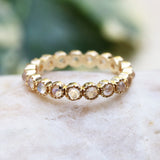 Tiny round cabochon moonstone eternity ring with 18k gold band