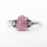 Ruby ring with moonstone side set gems in prongs setting with sterling silver oxidized texture band