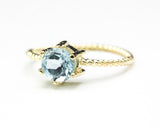 Round faceted  blue topaz ring in prongs setting with 14k gold twist band