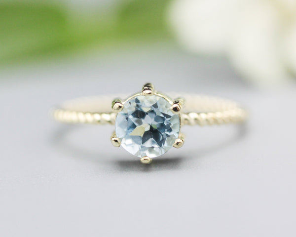 Round faceted  blue topaz ring in prongs setting with 14k gold twist band