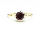 Round faceted garnet ring in prongs setting with 14k gold twist band