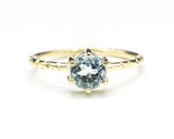 Round faceted blue topaz ring in prongs setting with 14k gold texture design band