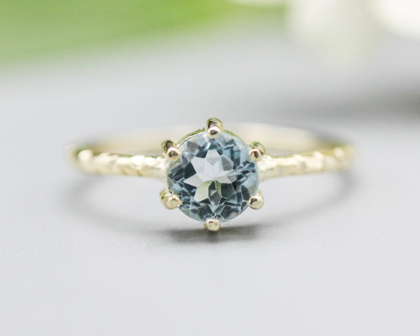 Round faceted blue topaz ring in prongs setting with 14k gold texture design band