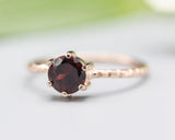 Round faceted garnet ring in prongs setting with 14k rose gold texture design band