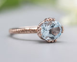 Blue topaz cocktail ring in prongs setting with 14k rose gold texture design band