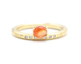 Oval cabochon sunstone ring in prongs setting with tiny diamonds on 14k gold line texture design band