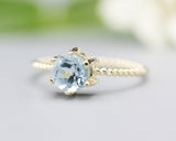 Round faceted  blue topaz ring in prongs setting with 14k gold twist band