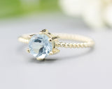 Round faceted  blue topaz ring in prongs setting with 14k gold twist band