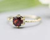 Round faceted garnet ring in prongs setting with 14k gold texture design band