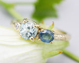 14k gold wedding ring with blue topaz, blue sapphire, diamond gemstone in bezel and prongs setting