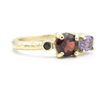 14k gold wedding ring with Garnet, amethyst, black spinel gemstone in bezel and prongs setting.