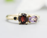 14k gold wedding ring with Garnet, amethyst, black spinel gemstone in bezel and prongs setting.