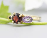 14k gold wedding ring with Garnet, amethyst, black spinel gemstone in bezel and prongs setting.