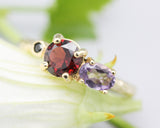 14k gold wedding ring with Garnet, amethyst, black spinel gemstone in bezel and prongs setting.