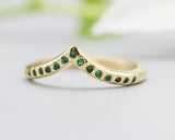 14k gold with geometric design band ring with tiny 15 emerald on the center