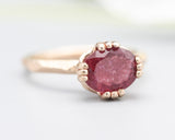 Pink tourmaline cocktail ring in prongs setting with 14k rose gold geometric design band