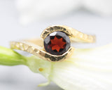 Bypass style ring 14k gold hammer texture design with round faceted Garnet at the center