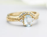 Set of 2 Oval faceted blue topaz ring with tiny round diamonds side set with 14k gold band ring with tiny 7 diamond on the center