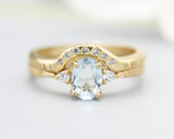 Set of 2 Oval faceted blue topaz ring with tiny round diamonds side set with 14k gold band ring with tiny 7 diamond on the center