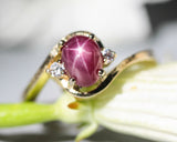 Oval star ruby ring and twin side set diamonds with 14k gold wood texture band
