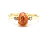 Oval cabochon Sunstone ring with tiny round diamonds side set gems in prongs setting with 14k gold half round band