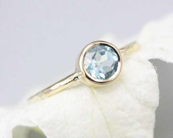 Round faceted Blue topaz in bezel settings with 14k gold texture band